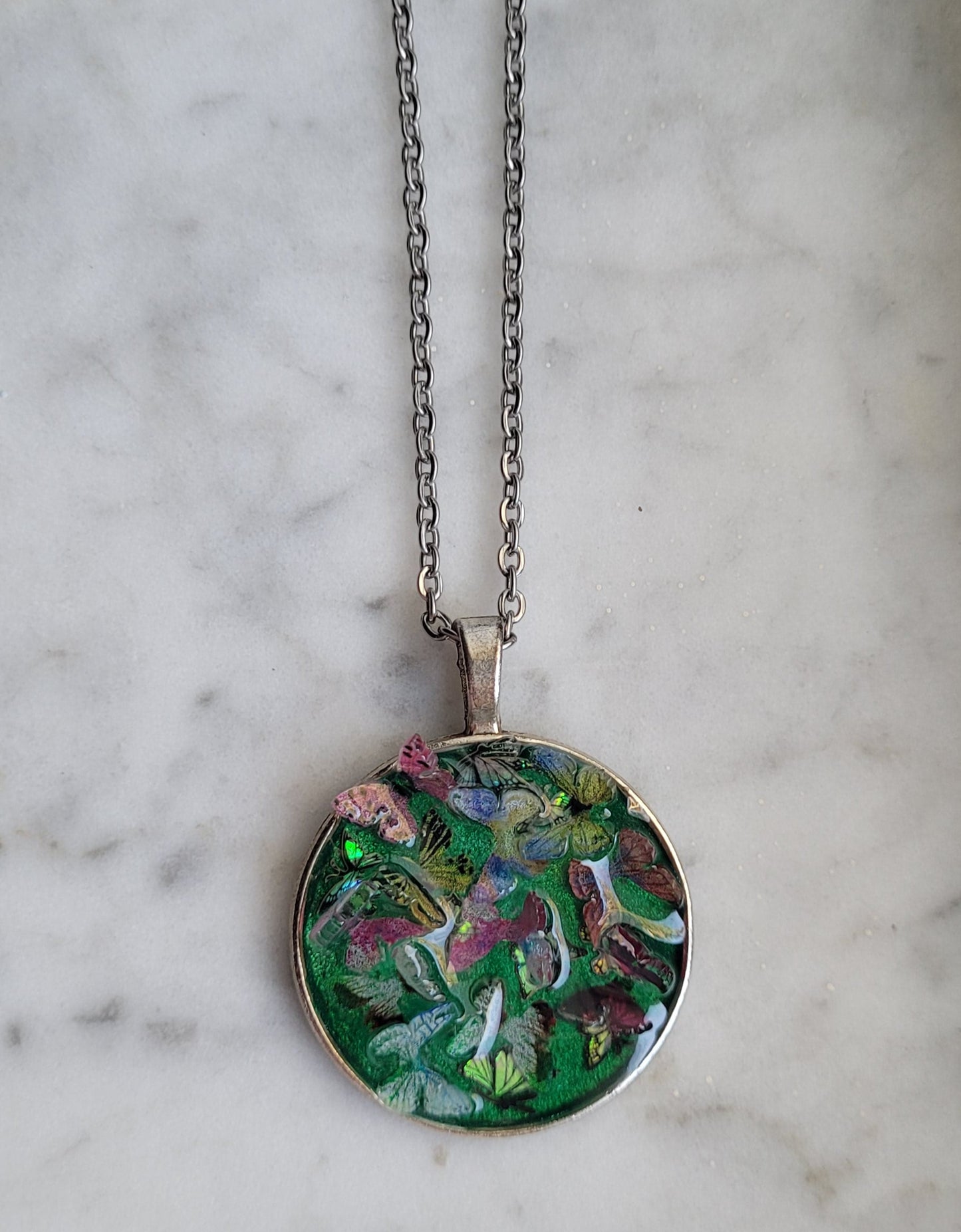 Necklace with a butterfly pendant on a marble surface