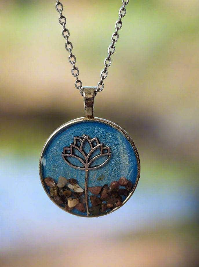 Necklace with a round pendant featuring a floral design on a blue background
