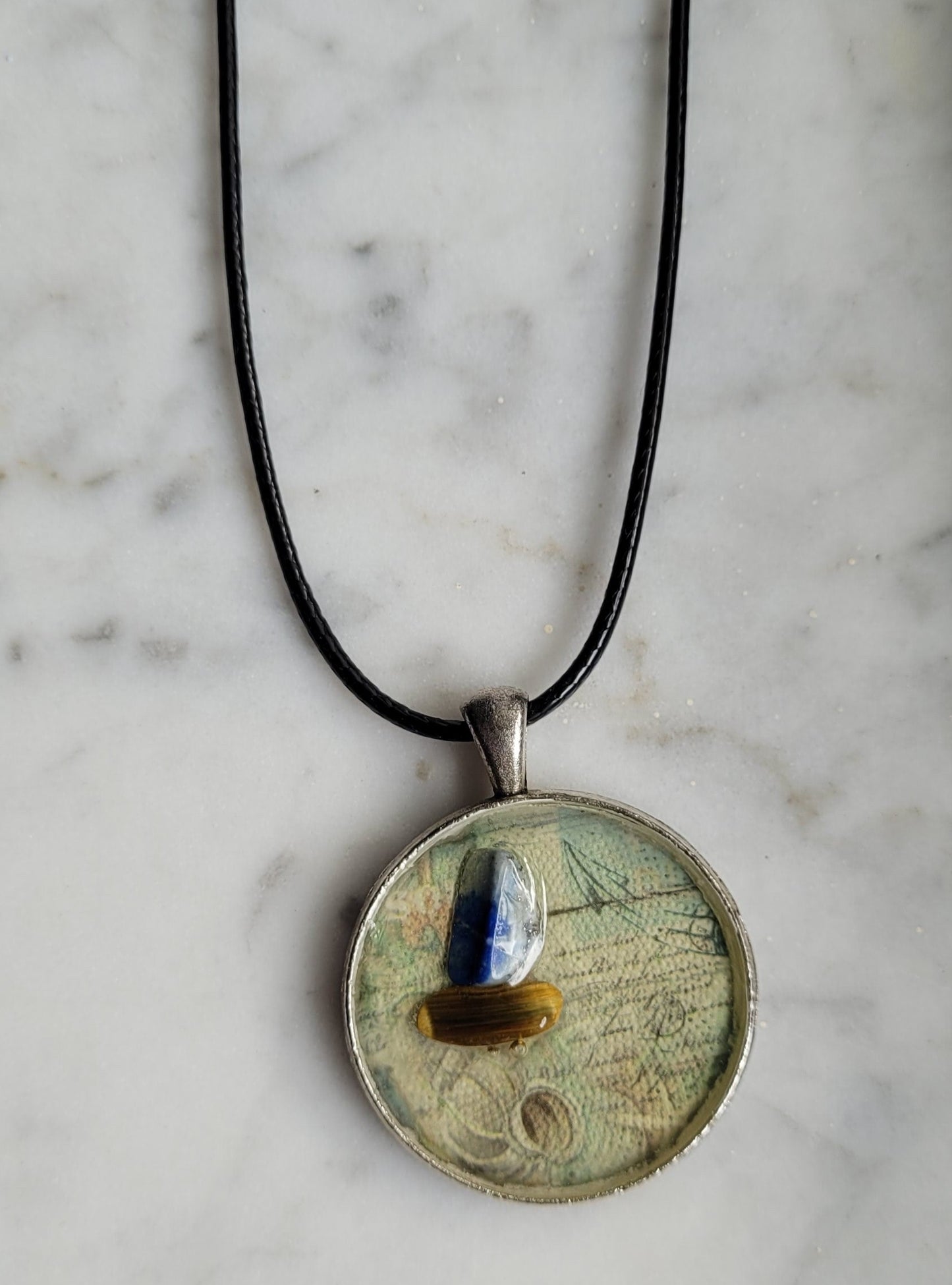 Necklace with a round pendant on a marble surface