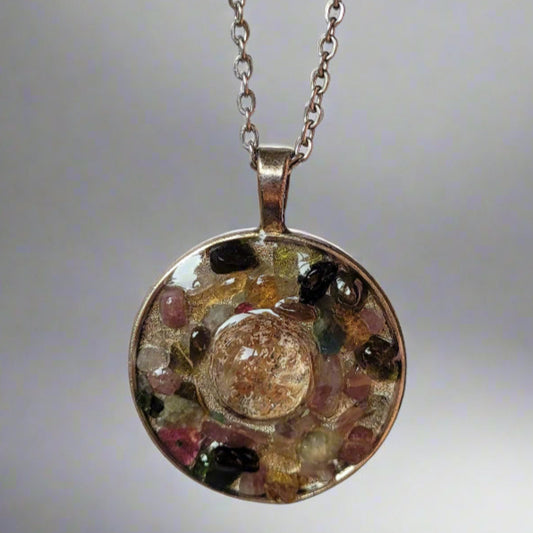 Necklace with a round pendant featuring a face design on a light background