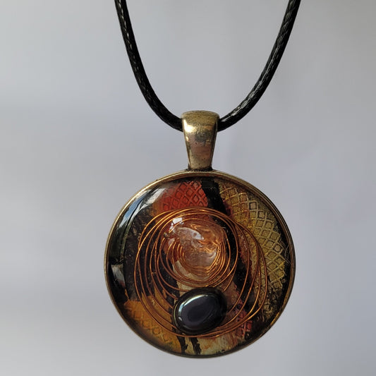 Round pendant necklace with a black cord on a white background