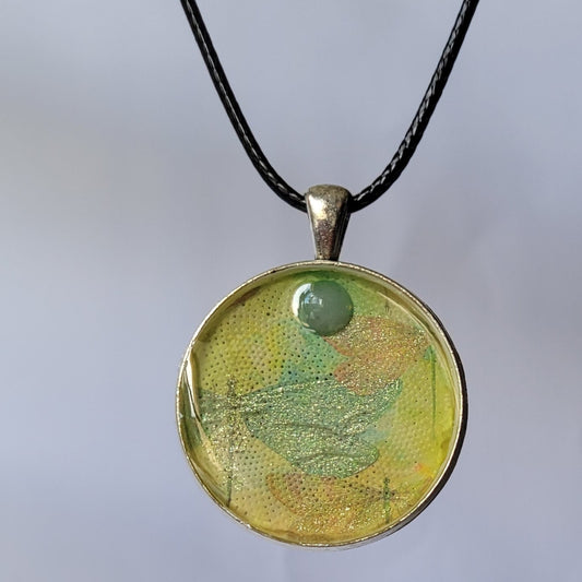 Necklace with a round pendant featuring a tree design on a white background